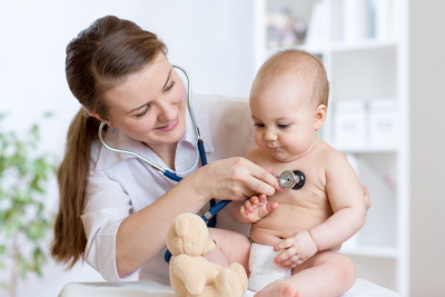 Cute woman pediatrician examining of baby kid with stethoscope