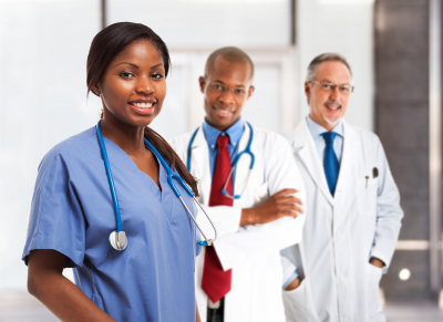 Portrait of a smiling nurse in front of her medical team